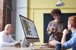 Man in Blue Collared Top Using Imac Indoors Free Stock Photo