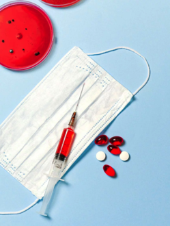 Syringe and Pills on Blue Background Free Stock Photo