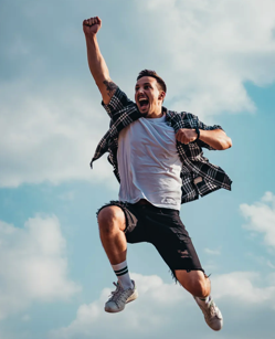 Low Angle Photography of Man Jumping Free Stock Photo