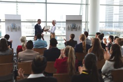 Businesswoman receiving award from businessman at TJCBDPE