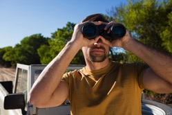 Man looking through binocular 7P6WSVK