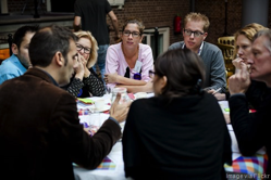 people talking around a dinner table.